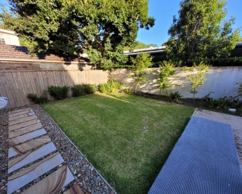 Landscape water feature integrated with paving and garden design