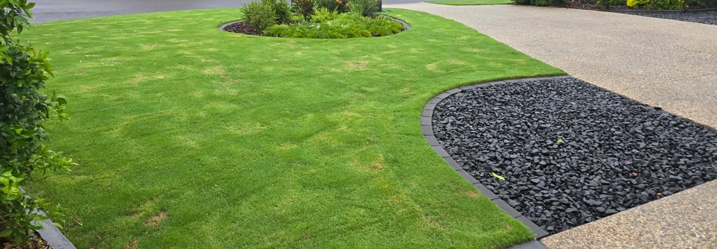 Artificial grass and natural turf installation in a Brisbane landscape