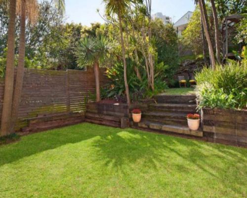 Outdoor landscape lighting illuminating garden planting and pathways
