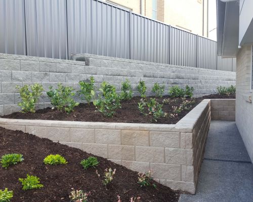 Landscape retaining wall creating a level garden area in Brisbane