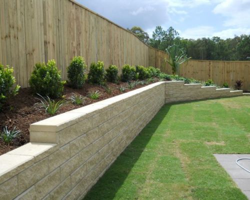 Finished retaining wall integrated into a landscaped outdoor area
